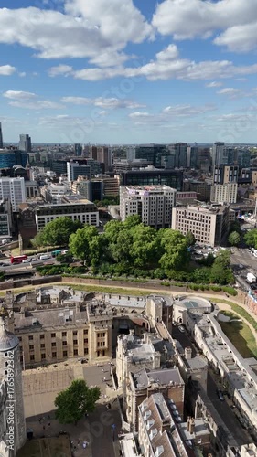 Cinematic 4K drone footage of the Tower of London and Tower Bridge, showcasing the historic fortress, River Thames, and the vibrant London skyline under clear summer light.