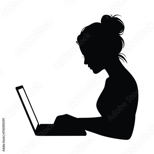Silhouette of a woman working on a laptop computer