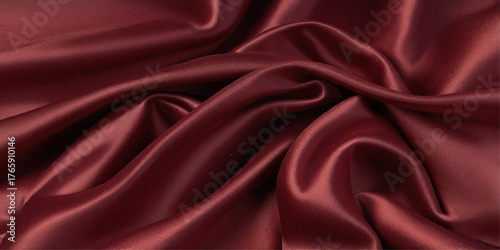 Close-up of a rich, deep red satin fabric. A close-up shot showcasing the luxurious drape and texture of a deep red satin fabric.	
