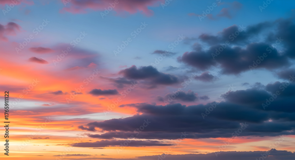 Fototapeta premium Stunning vibrant sunset paints the sky with fiery oranges pinks and dramatic dark clouds creating a breathtaking natural spectacle