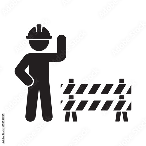 Construction worker in hard hat standing next to a safety barrier