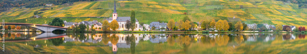 Fototapeta premium Piesport village and St. Michael church reflected in Moselle river. Germany