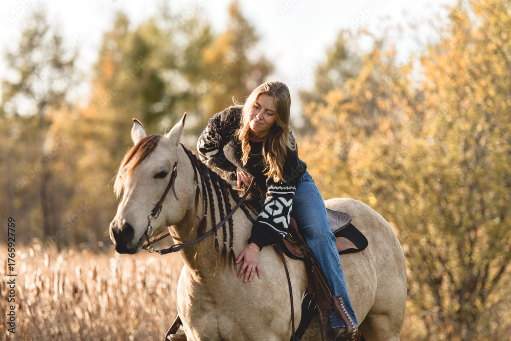 Fototapeta premium Young woman having great time with a horse in field on autumn season. sunset hour