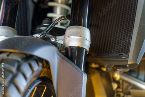 Close-up view of a motorcycle front suspension system showcasing design and engineering details