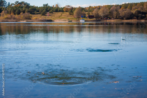 Ripples and splashes on water surface from skipping stones