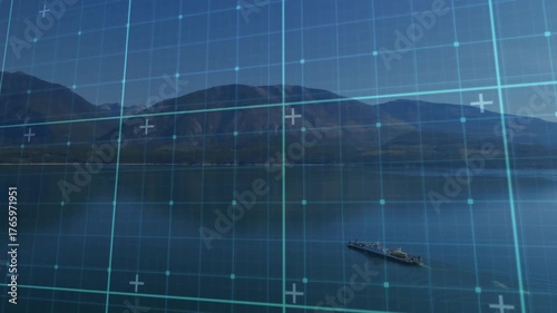 Digital grid overlaying mountain lake while cargo vessel moving across still water for mapping