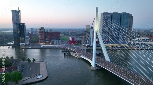 Drone flight over Rotterdam, Netherlands. New skyscrapers, city canyon, navigable canals and drawbridges in the light of sun or sunrise, drone shot. 4K
