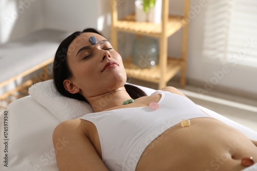 Принти на полотні Woman undergoing crystal therapy to heal or restore her aura indoors