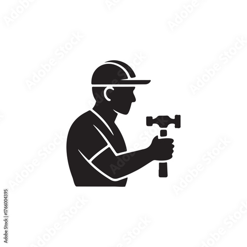Construction worker with hammer depicted in a striking black silhouette