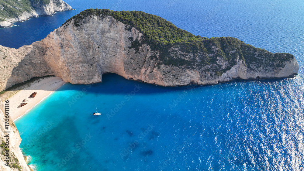 Obraz premium Aerial drone photo of famous steep rocky white cliffs creating beautiful coves and turquiose sea caves of Kampi visited by small boats and yachts in northern part of Zakinthos island, Ionian, Greece