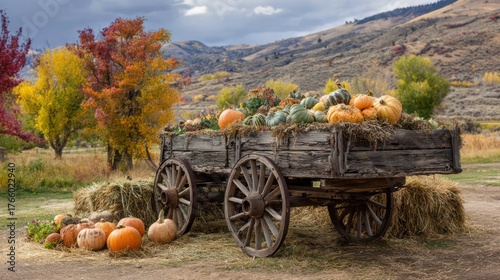 Rustic wooden wagon overflows with pumpkins, hay bales, and autumn foliage