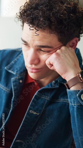 Bored, employee and man in office, tired and journalist with low energy, think and unhappy with job. Frustrated, reporter and person with burnout in newsroom, reflection and lazy with exhaustion