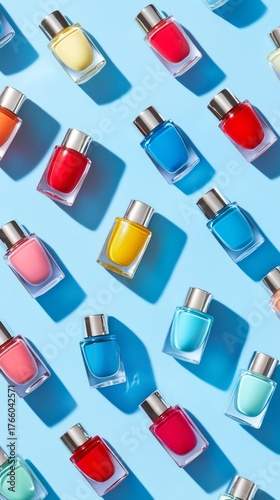 Colorful Nail Polish Bottles Arranged on a Light Blue Background Showcasing V...