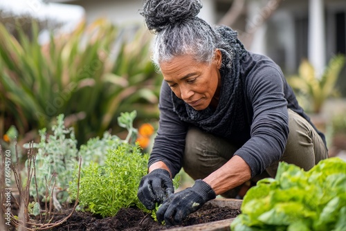 Gardening Woman Tending to Young Plants in Her Backyard During a Sunny Day