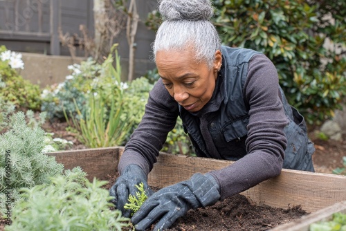 Gardening Activity in a Home Garden With a Woman Tending to Plants in the Aft...