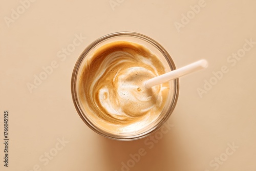 Enjoying a Creamy Coffee Drink With a Straw in a Cozy Setting During the Afte...