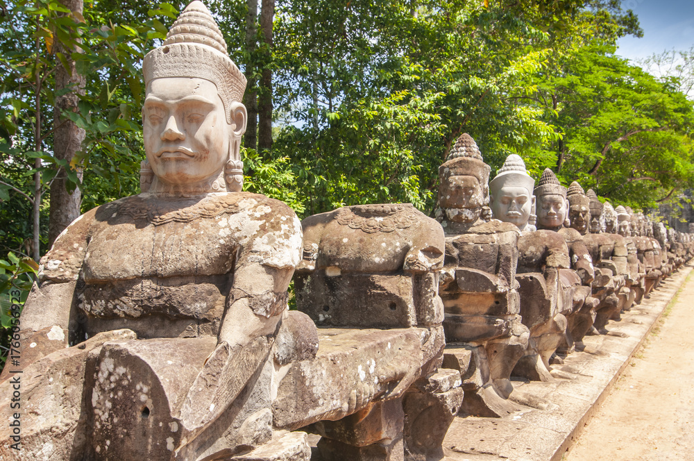 Fototapeta premium Row of sculptures in the South Gate of in complex Angkor Wat in Siem Reap, Cambodia.