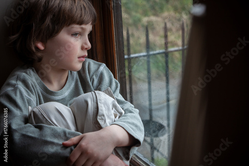 Sad Depressed Boy Young Male Child Looking Out of a Window