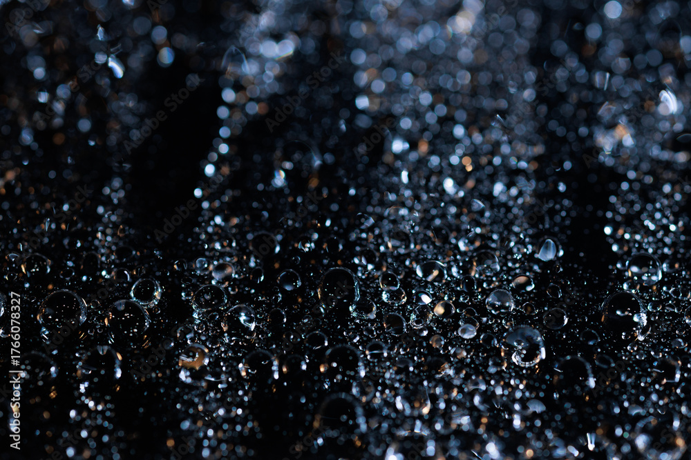 Fototapeta premium raindrops on a dark background.water drops on glass in close-up. Abstract dark background. Mockup for your logo. horizontal wallpaper or web banner.