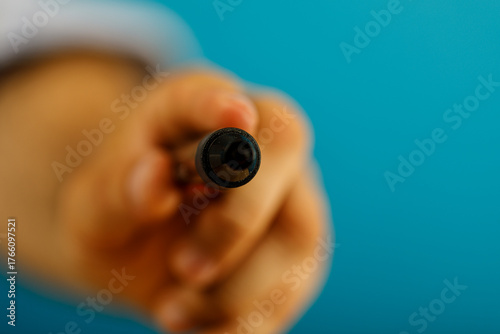 A person's hand holding a p...