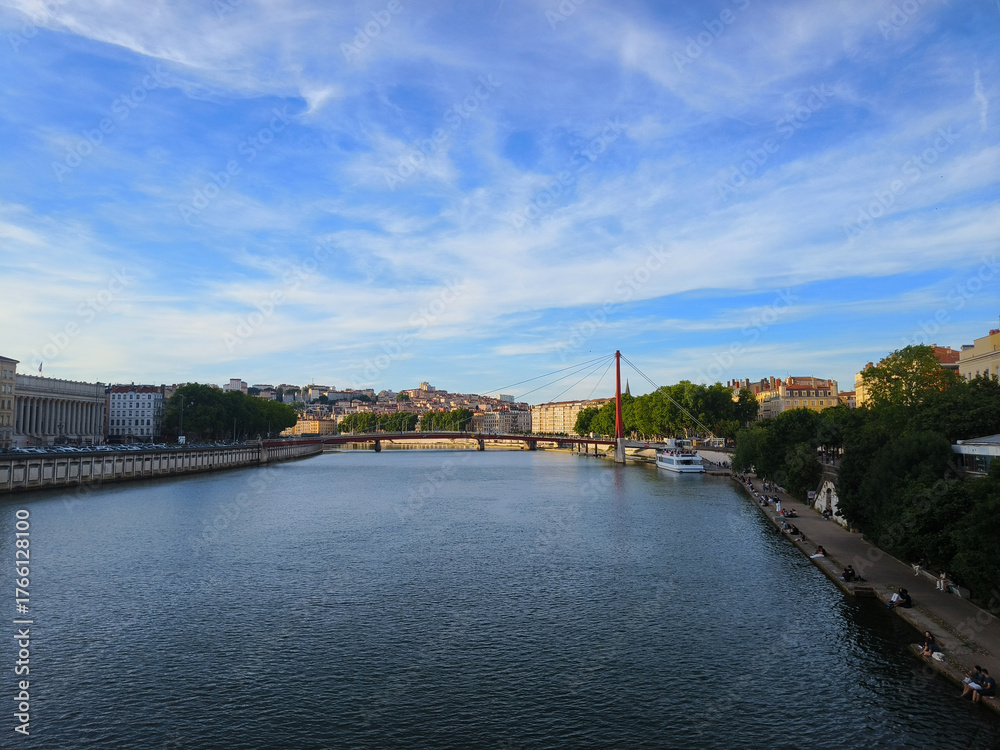 Obraz premium Lyon, France, May 29, 2025, View of the Rhone River and its embankment, waterfront Blue Sky