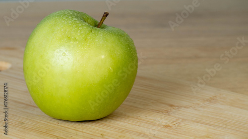 green apple on wooden table