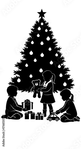 Three young children joyfully unwrap presents and play with new toys beneath a beautifully decorated Christmas tree, celebrating the festive holiday season.