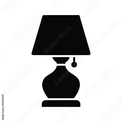 Silhouette of a table lamp with a lampshade, bulb, and base against white background