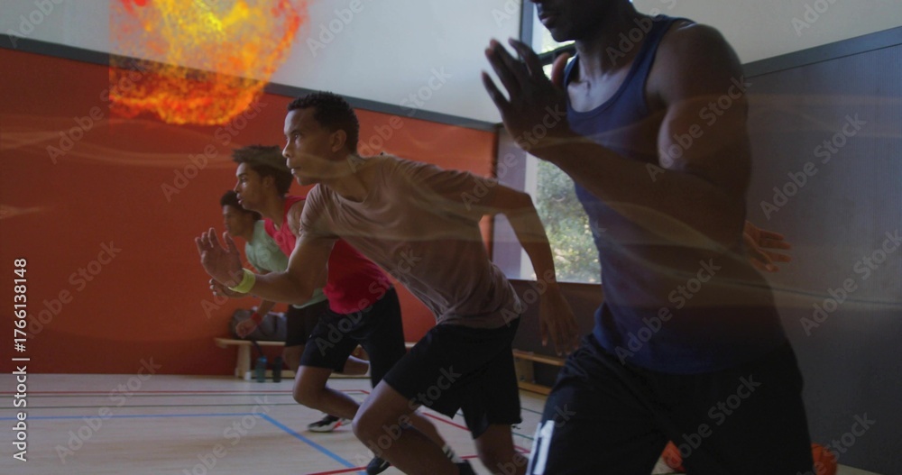Fototapeta premium Leaning forward four male athletes in sportswear launching sprint drills at gym, with basketball