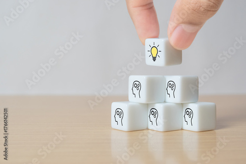 Concept creative idea and innovation. Hand picked white dice with head human symbol and light bulb icon