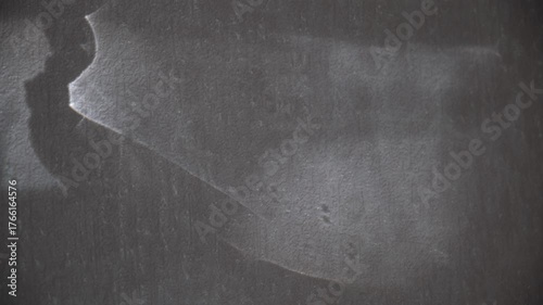 Textured surface like animal skin, on which gleams of light cast fanciful shadows. The twilighty shadows danced across the dark background, grotesque twilight loomed against the wall. Surreal backdrop