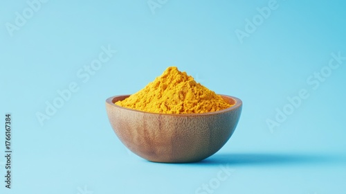 Turmeric Powder in Wooden Bowl, Vibrant Yellow Spice
