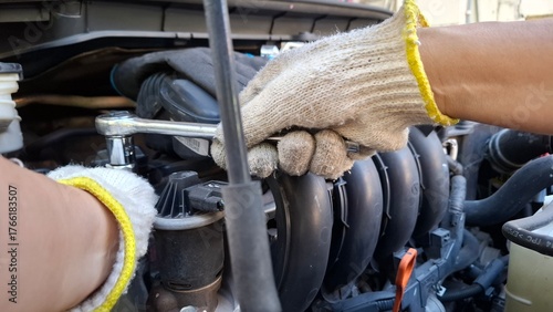 mechanic changing car engine