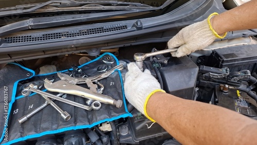 mechanic repairing car engine