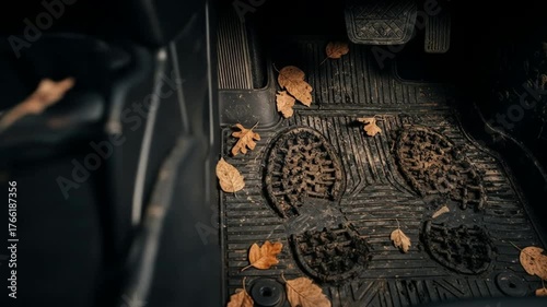 Tracking Mud Inside: Dirty Car Floor Mat with Leaves and Footprints