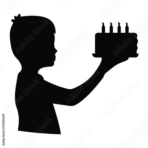 Silhouette of a young boy holding a birthday cake with lit candles in his hand