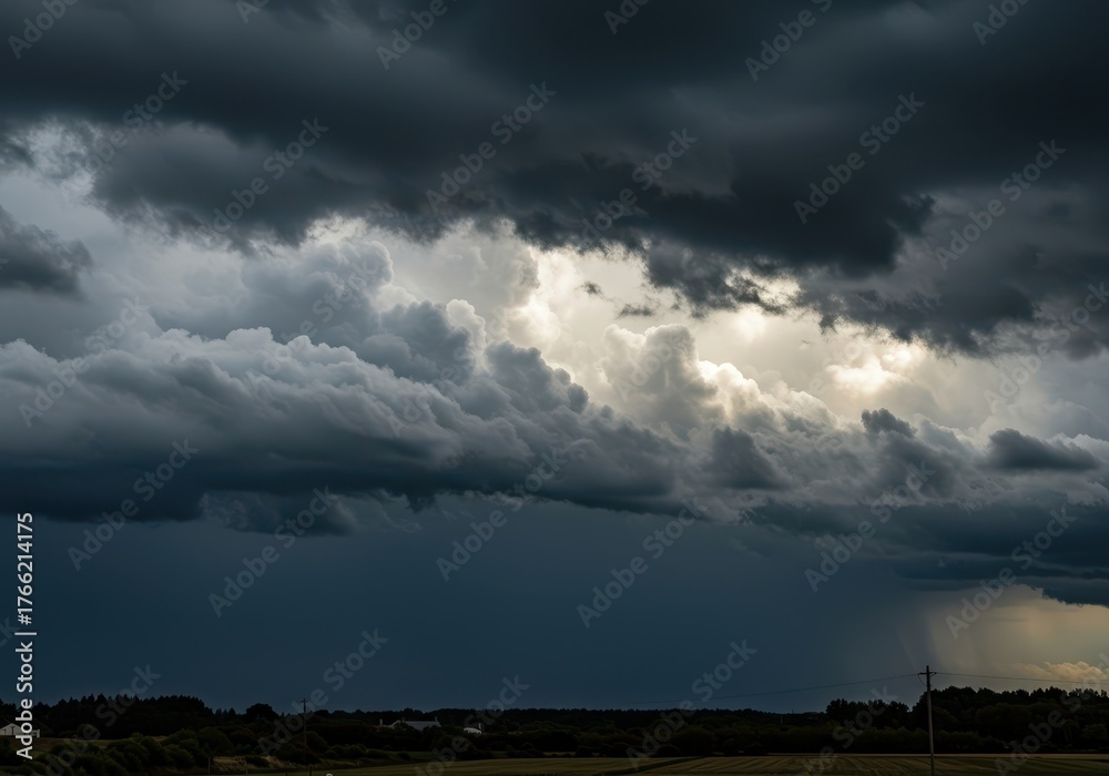 Obraz premium Dramatic view of a massive, dark cloudscape covering the entire sky, signaling an imminent heavy thunderstorm and downpour of rain ,vast ,sky ,dramatic