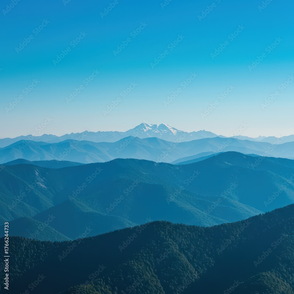 Naklejka premium Majestic blue mountains stretching under a clear, vibrant sky, showcasing a beautiful, expansive summer landscape view ,high ,forest ,slope