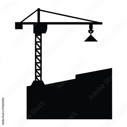 Silhouette of a towering construction crane lifting materials over a building site