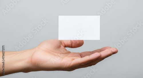 Hand holding a blank business card for branding and promotion.