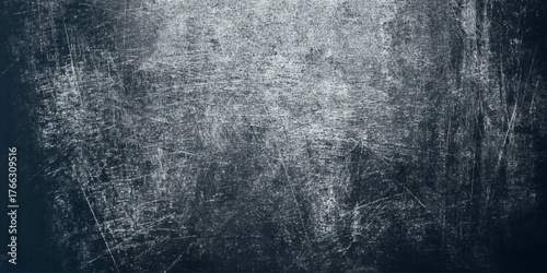 A wall textured surface by a deep gray color with varying shades scuffs, and a mottled, worn out appearance.