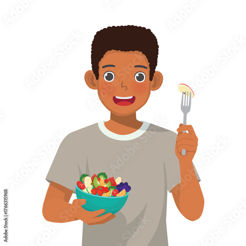 African man eating salad with a fork while holding a bowl of salad