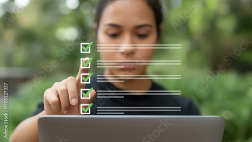 Woman checking off tasks on a digital checklist outdoors