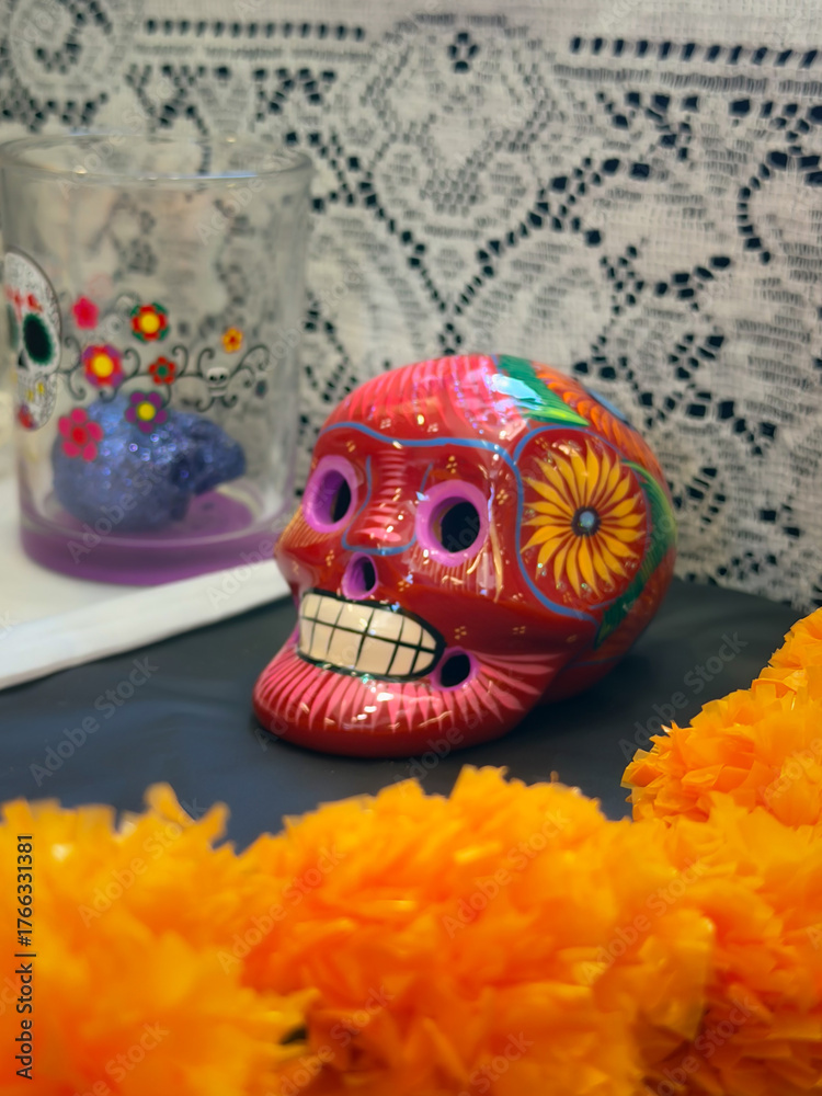 Fototapeta premium Colorful Sugar Skull With Vibrant Decorations and Marigold Flowers on an Altar for Day of the Dead Celebration