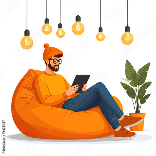 A man with a beard and glasses relaxes on an orange bean bag chair, using a tablet under warm hanging light bulbs, with a potted plant nearby.