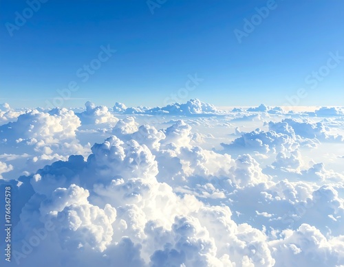 Fototapeta Naklejka Na Ścianę i Meble -  Aerial view of a bright blue sky filled with fluffy white clouds