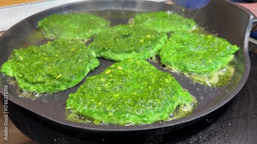 Unusual green spinach or broccoli fritters are pan-fried until crispy, offering a tasty and healthy snack or appetizer