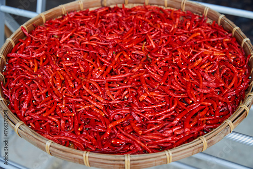 Fototapeta Naklejka Na Ścianę i Meble -  Red chili peppers in sun drying in wicker basket