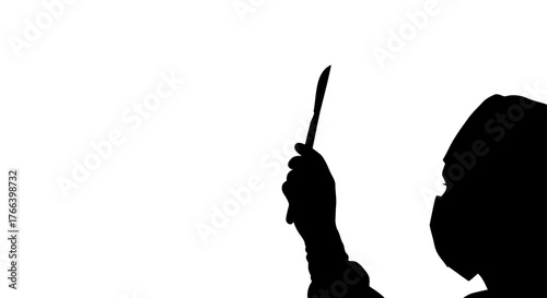 Silhouette of surgeon holding scalpel with gloved hand, ready for precise medical procedure, conveying focus and expertise in sterile operating room.
