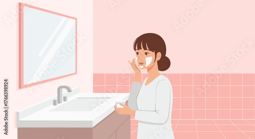 Beautiful woman applying facial cream in her pink bathroom, enjoying her skincare routine and pampering herself with beauty treatment for self care
